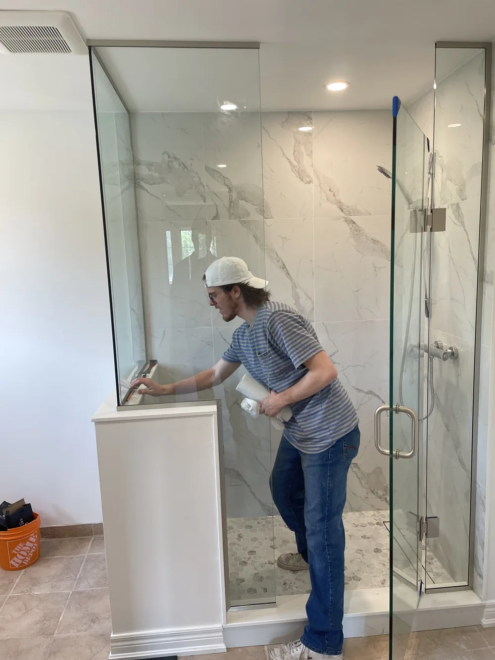 Glacier Glass installer aligning custom glass shower panel
