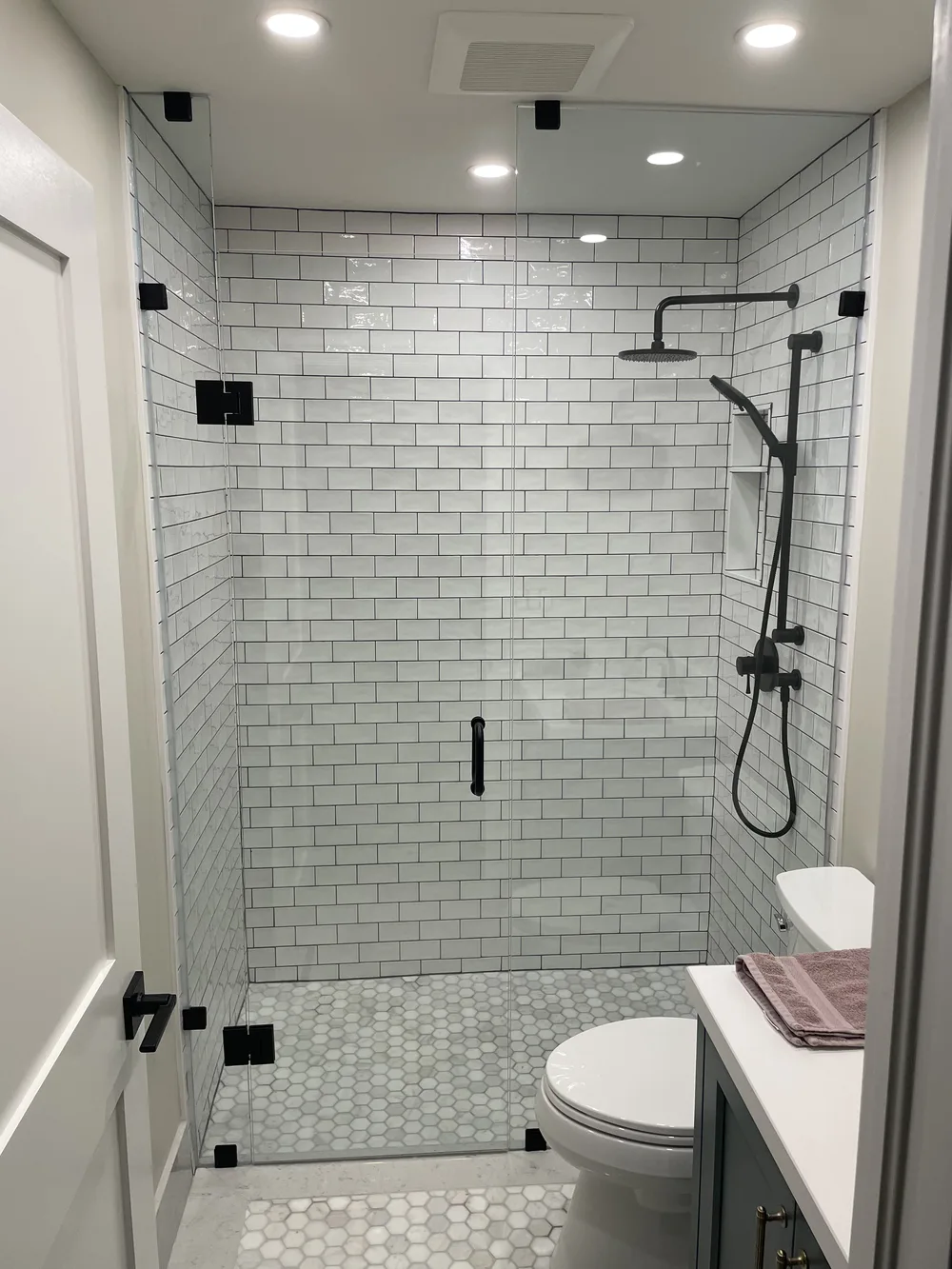 Heavy glass custom corner shower installation